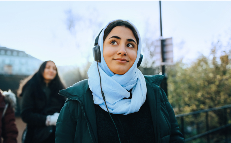 woman wearing headphones walking