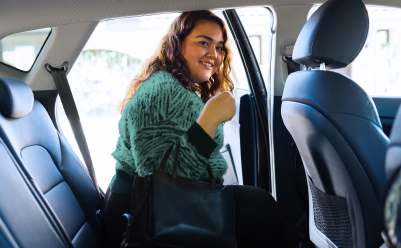 woman getting into car